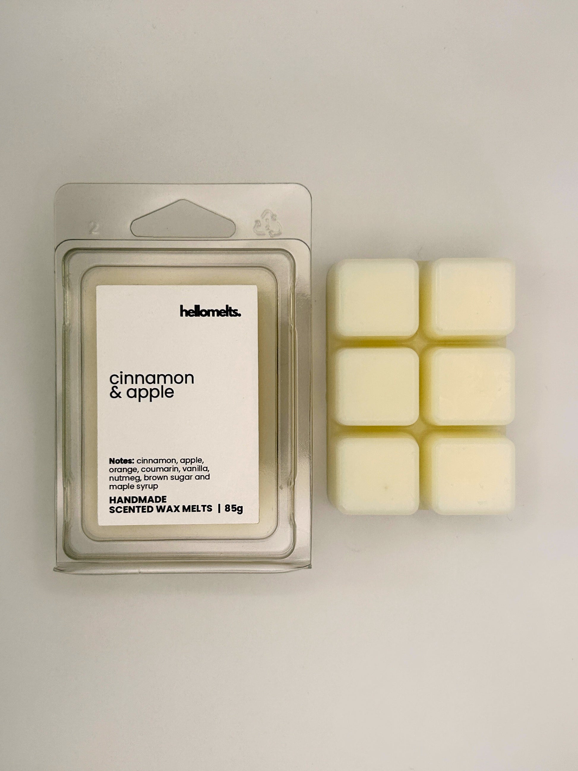 Cinnamon & Apple 85g wax melt bar displayed beside its clear clamshell packaging from the Hellomelts Autumn Collection