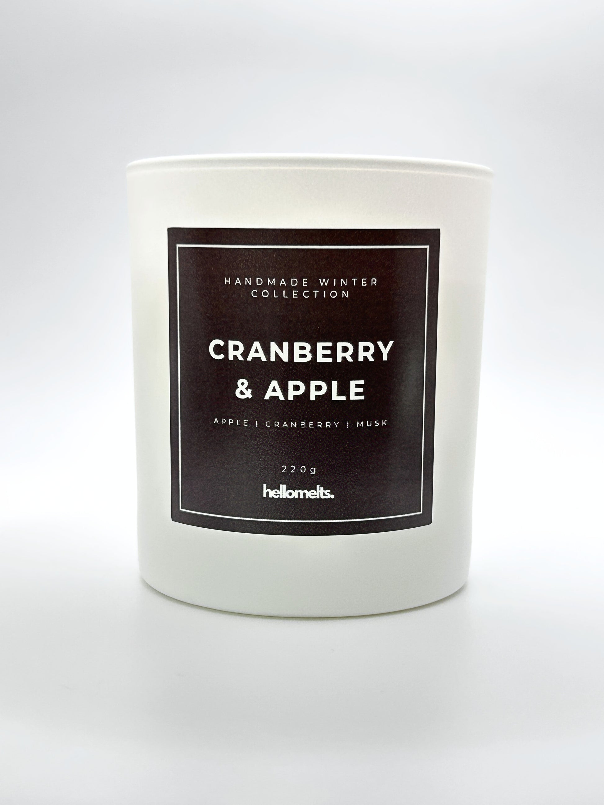 Cranberry & Apple 220g candle front-facing studio shot without the lid, showing the clean white jar and label from the Hellomelts Winter Collection