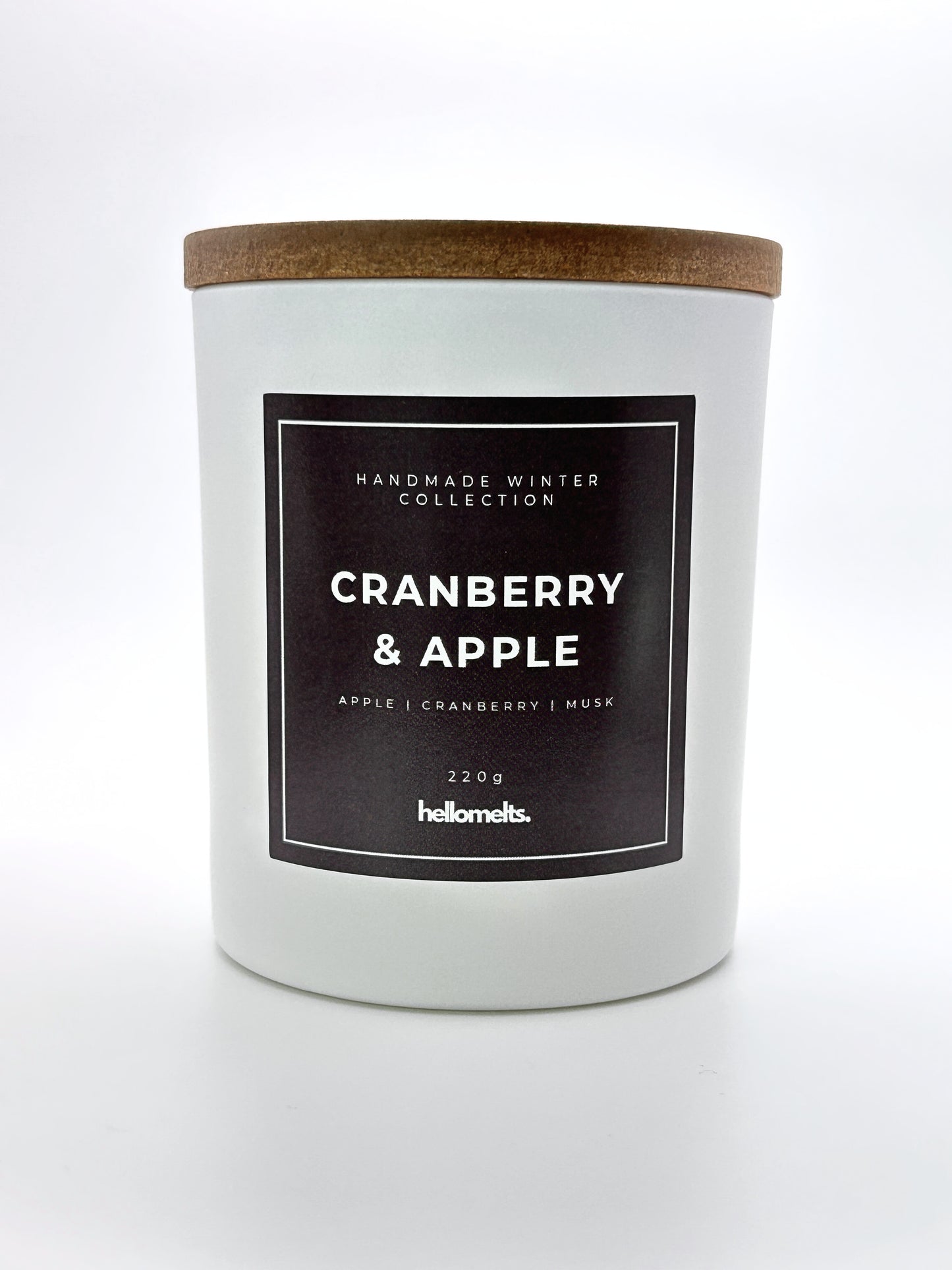 Cranberry & Apple 220g candle front-facing studio shot with wooden lid on, part of the Hellomelts Winter Collection