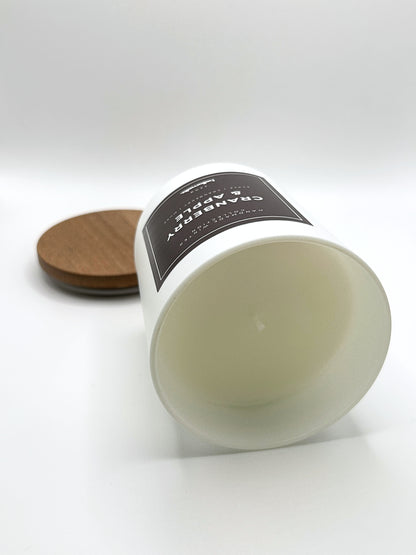 Cranberry & Apple 220g candle laid on its side with the lid in the background, showing the matte white jar from the Hellomelts Winter Collection