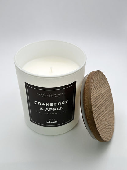 Cranberry & Apple 220g candle top-down view with the wooden lid placed beside the jar, part of the Hellomelts Winter Collection