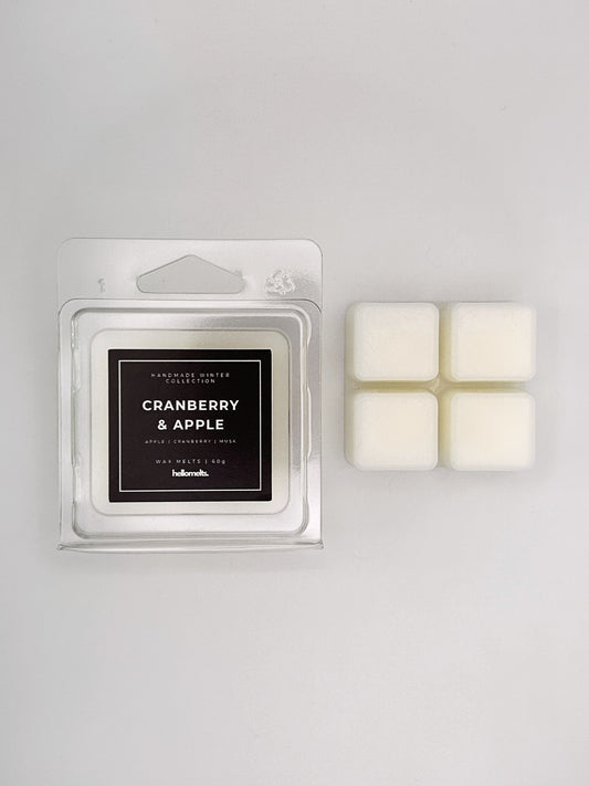 Cranberry & Apple 60g wax melt clamshell placed beside four wax cubes from the Hellomelts Winter Collection