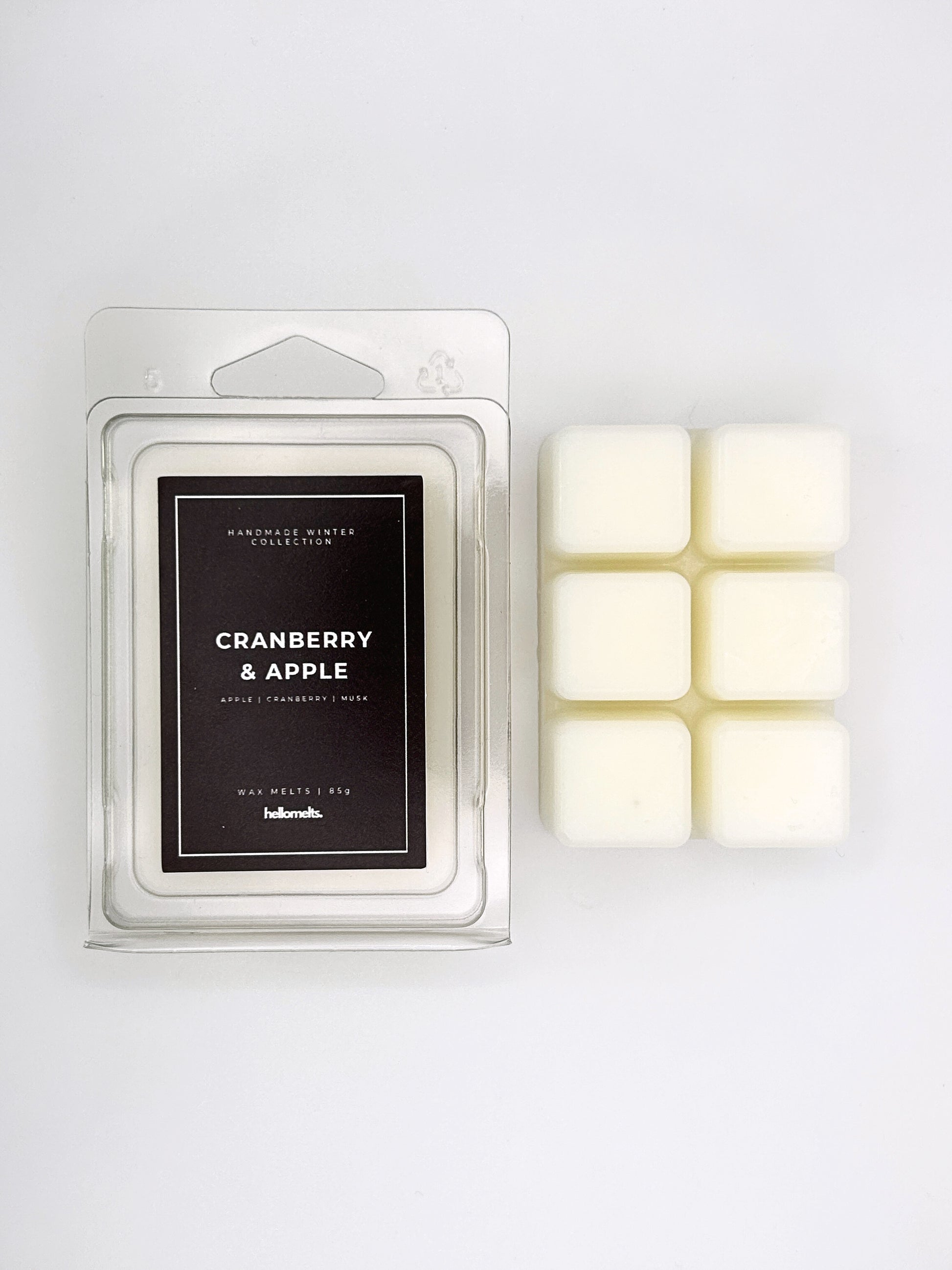 Cranberry & Apple 85g wax melt clamshell placed beside six wax cubes from the Hellomelts Winter Collection
