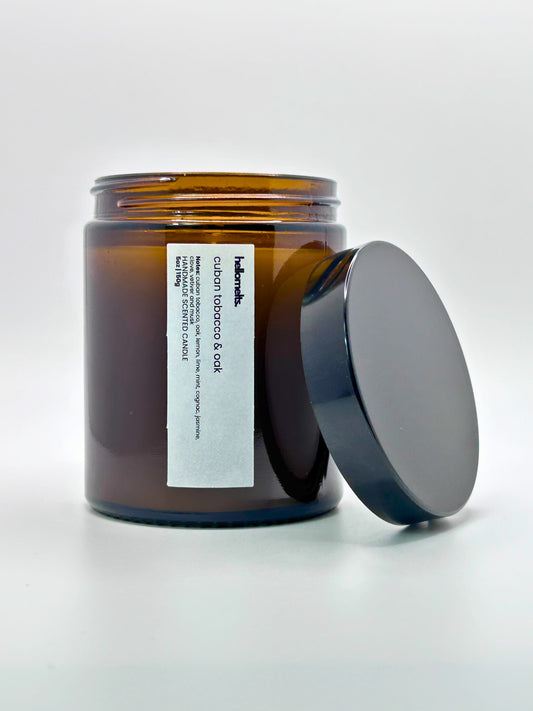 Front view of Cuban Tobacco & Oak autumn scented candle by Hellomelts with the lid placed beside it, part of the Autumn Collection