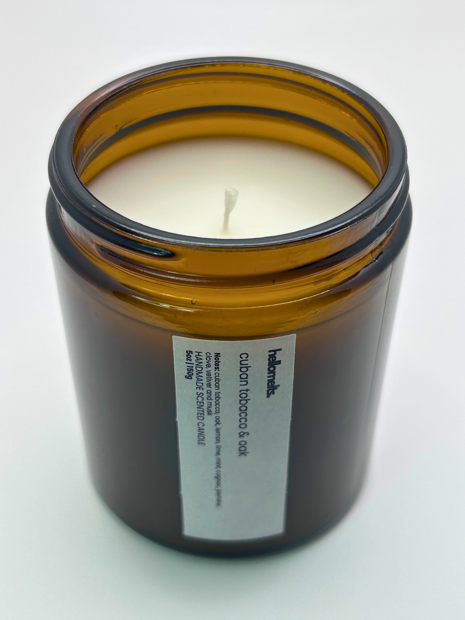 Angled top-down view of Cuban Tobacco & Oak autumn candle by Hellomelts, highlighting the wick and hand-poured wax, part of the Autumn Collection