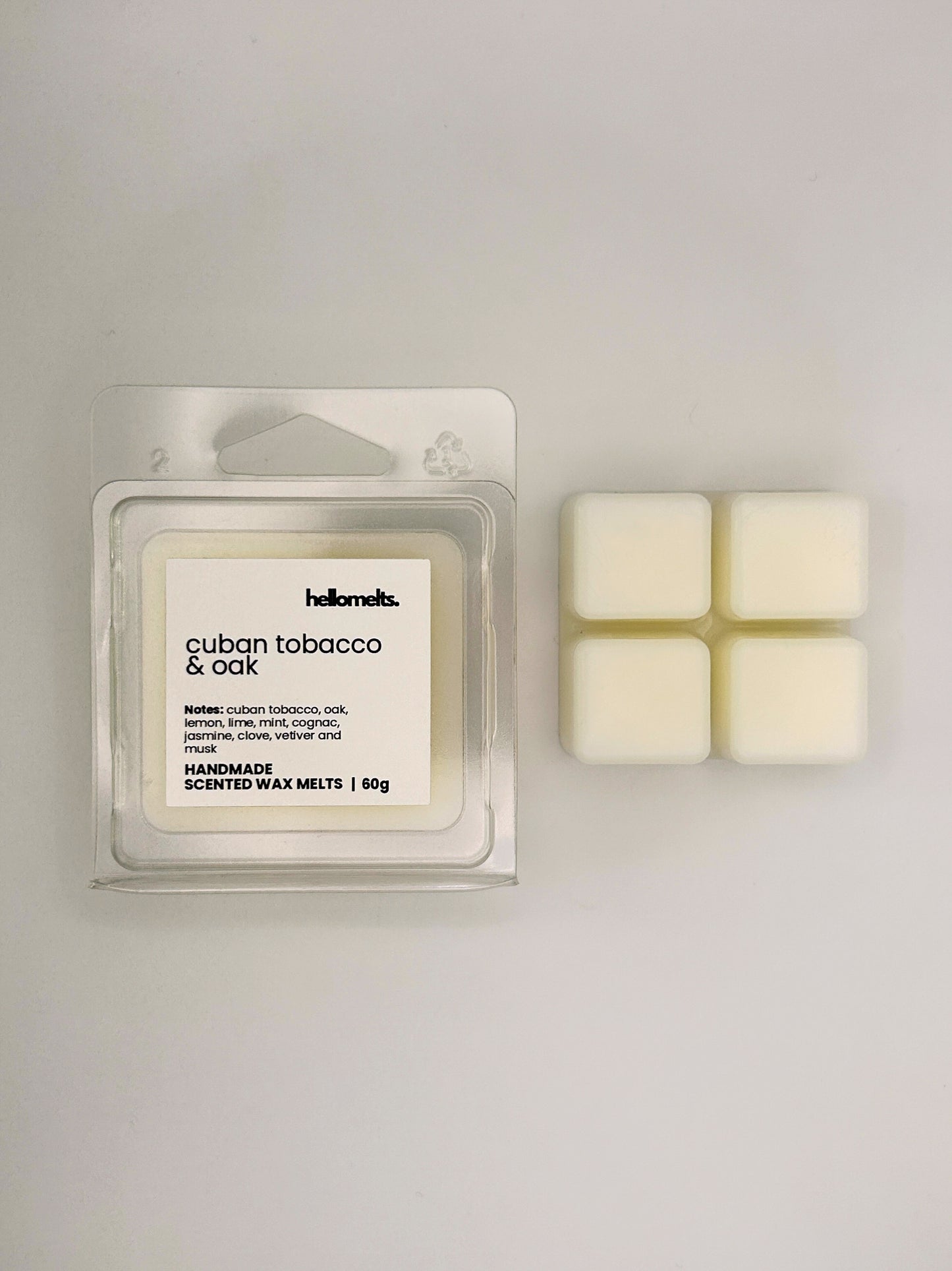 Cuban Tobacco & Oak 60g wax melt bar displayed beside its clear clamshell packaging from the Hellomelts Autumn Collection