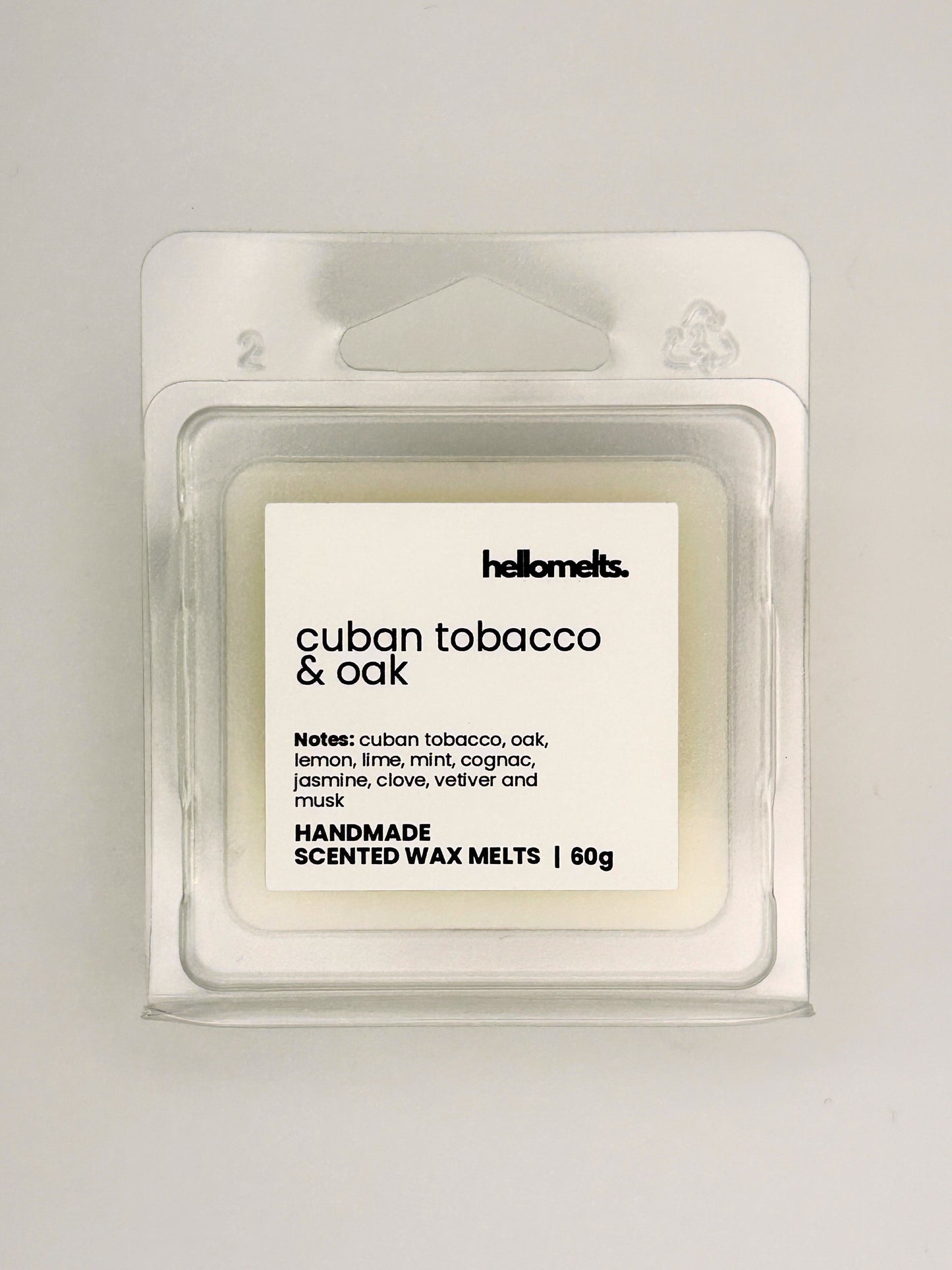 Close up of Cuban Tobacco & Oak 60g wax melt label on clear clamshell packaging from the Hellomelts Autumn Collection