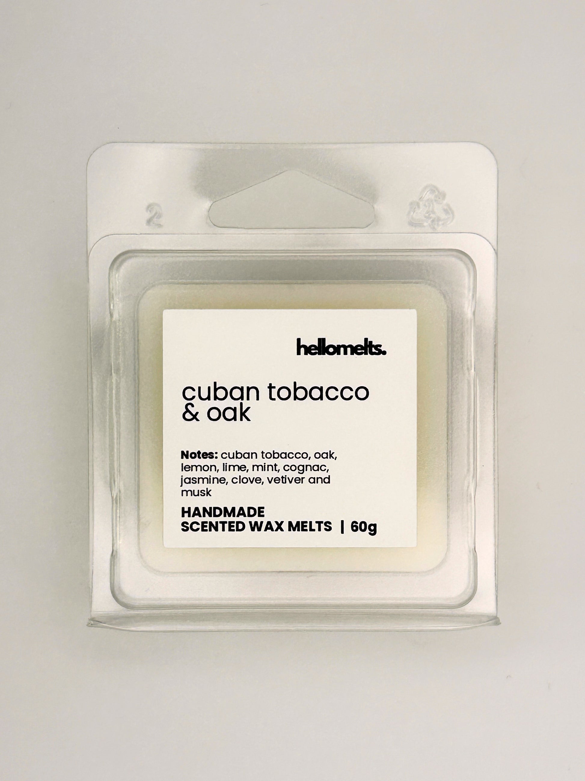 Close up of Cuban Tobacco & Oak 60g wax melt label on clear clamshell packaging from the Hellomelts Autumn Collection