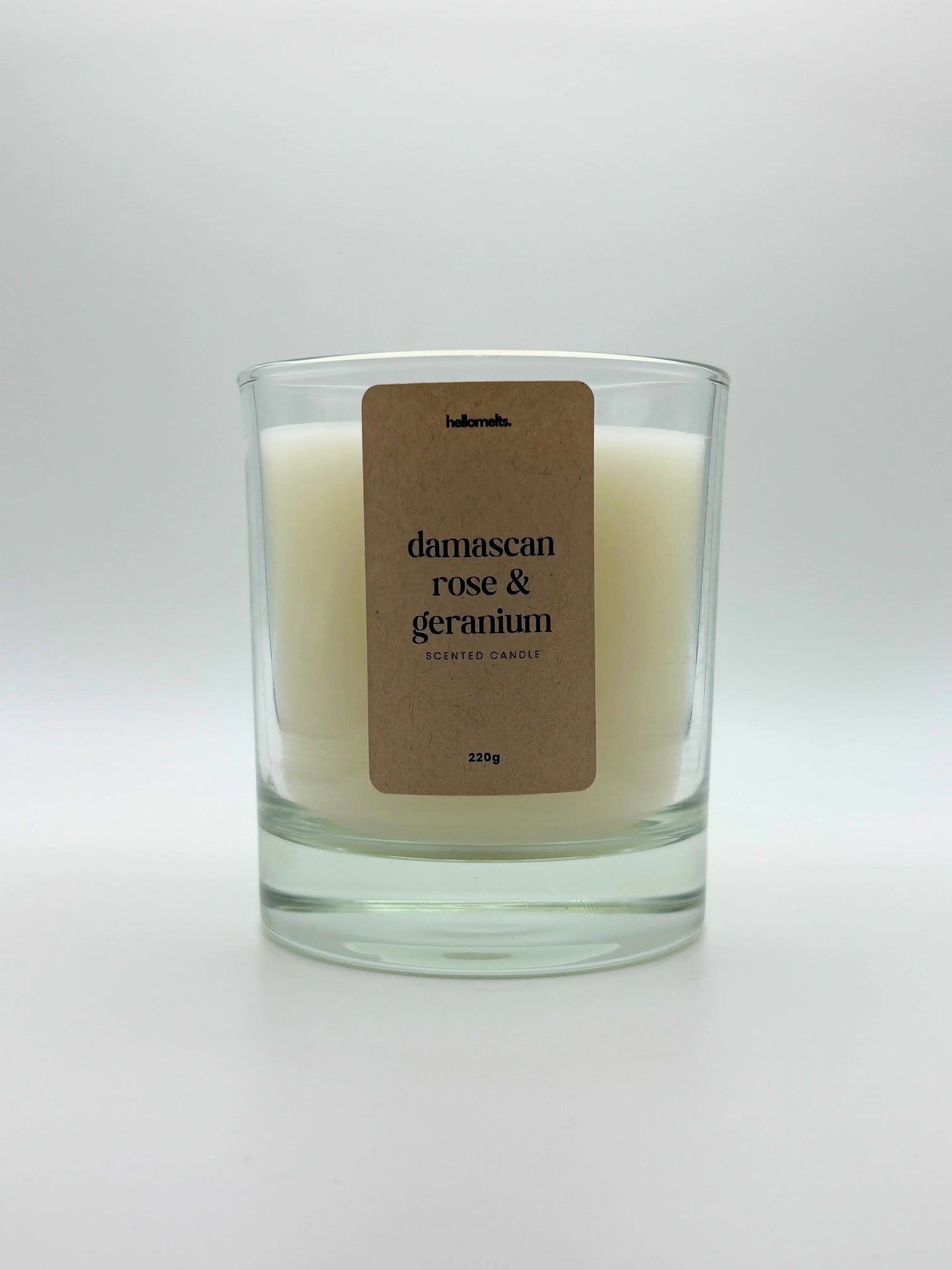 Front view of Damascan Rose & Geranium scented candle by Hellomelts, featuring a clean white wax in a clear glass jar, part of the Spring Collection.