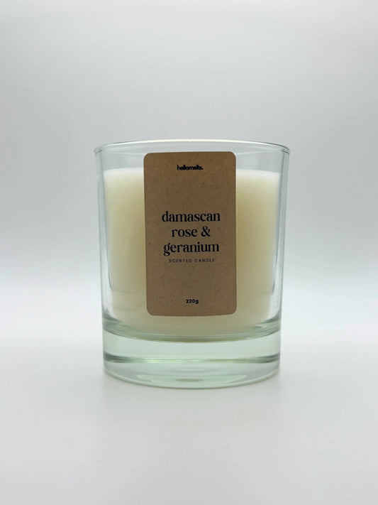 Front view of Damascan Rose & Geranium scented candle by Hellomelts, featuring a clean white wax in a clear glass jar, part of the Spring Collection.