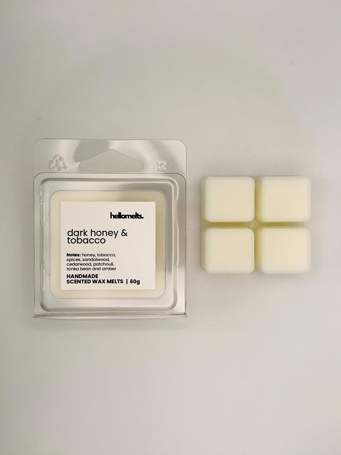 Dark Honey & Tobacco 60g wax melt bar displayed beside its clear clamshell packaging from the Hellomelts Autumn Collection