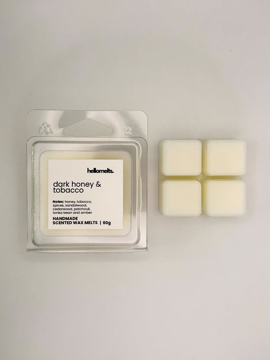 Dark Honey & Tobacco 60g wax melt bar displayed beside its clear clamshell packaging from the Hellomelts Autumn Collection