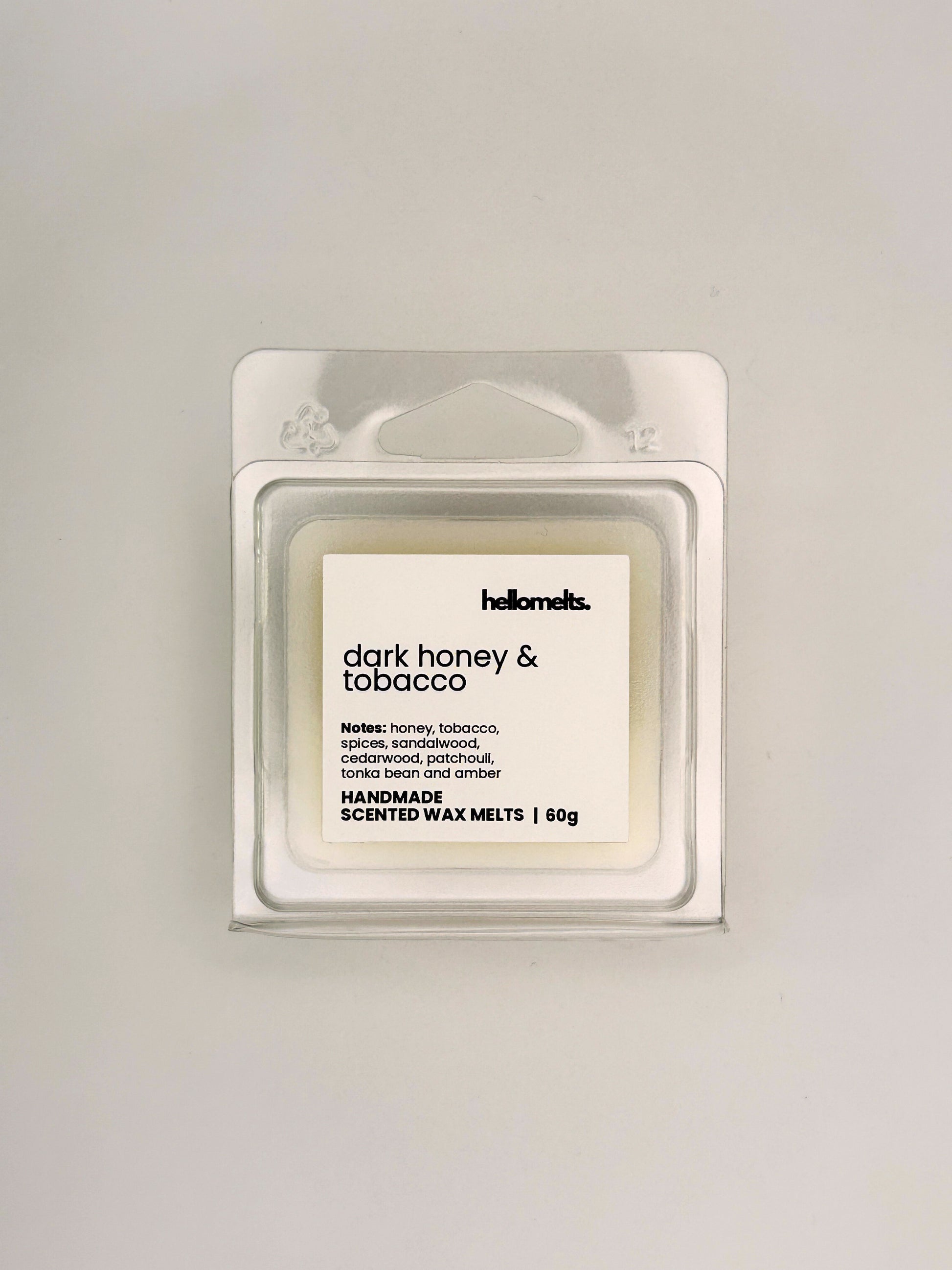 Front view of Dark Honey & Tobacco 60g wax melt in clear clamshell packaging from the Hellomelts Autumn Collection