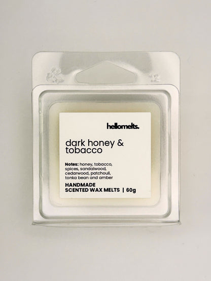 Close up of Dark Honey & Tobacco 60g wax melt label on clear clamshell packaging from the Hellomelts Autumn Collection