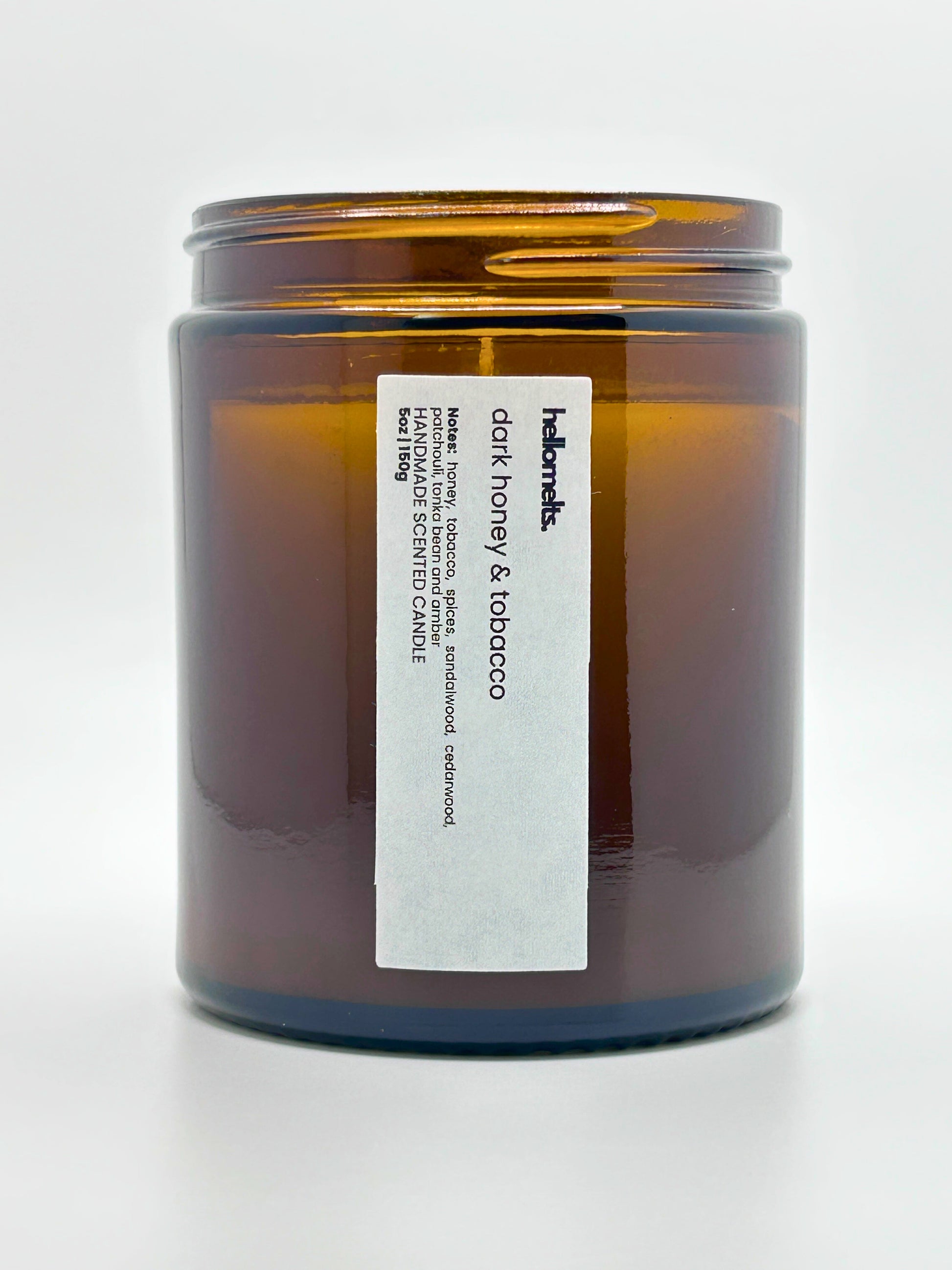 Close-up front view of Dark Honey & Tobacco autumn scented candle by Hellomelts with the lid off, part of the Autumn Collection