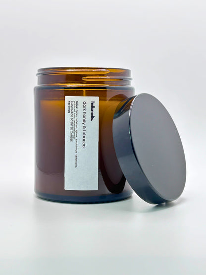 Front view of Dark Honey & Tobacco autumn scented candle by Hellomelts with the lid placed beside it, part of the Autumn Collection