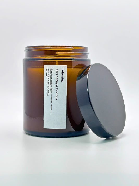 Front view of Dark Honey & Tobacco autumn scented candle by Hellomelts with the lid placed beside it, part of the Autumn Collection