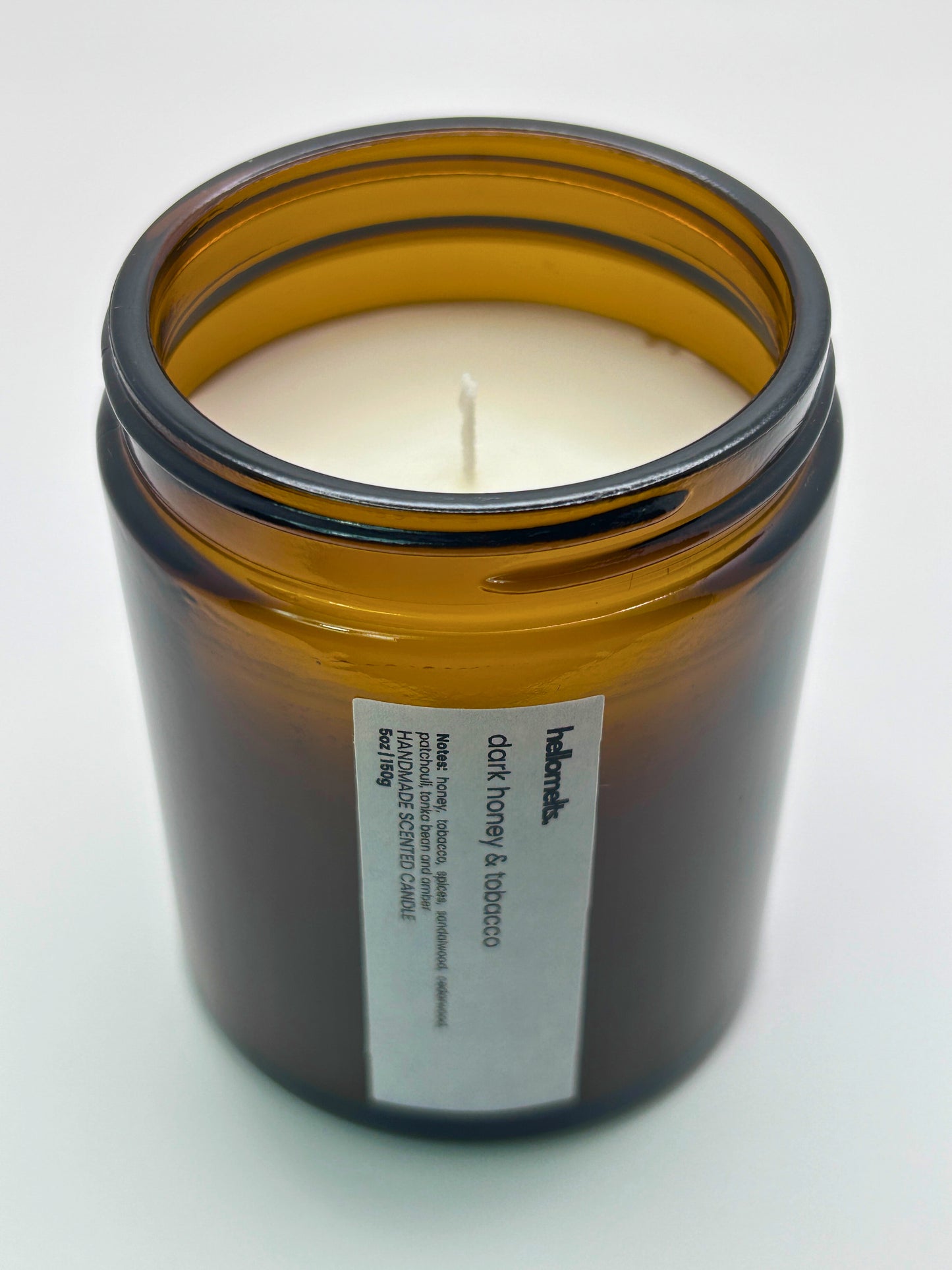 Angled top-down view of Dark Honey & Tobacco autumn candle by Hellomelts, highlighting the wick and hand-poured wax, part of the Autumn Collection