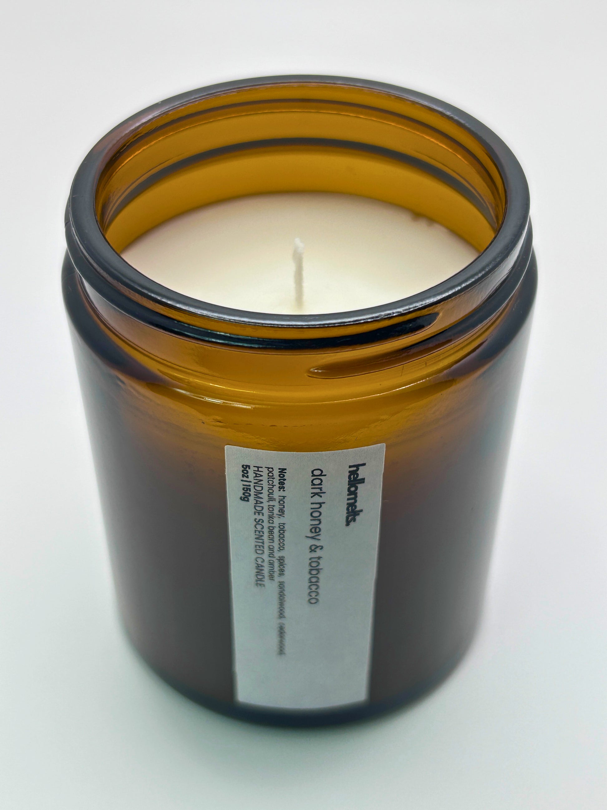 Angled top-down view of Dark Honey & Tobacco autumn candle by Hellomelts, highlighting the wick and hand-poured wax, part of the Autumn Collection
