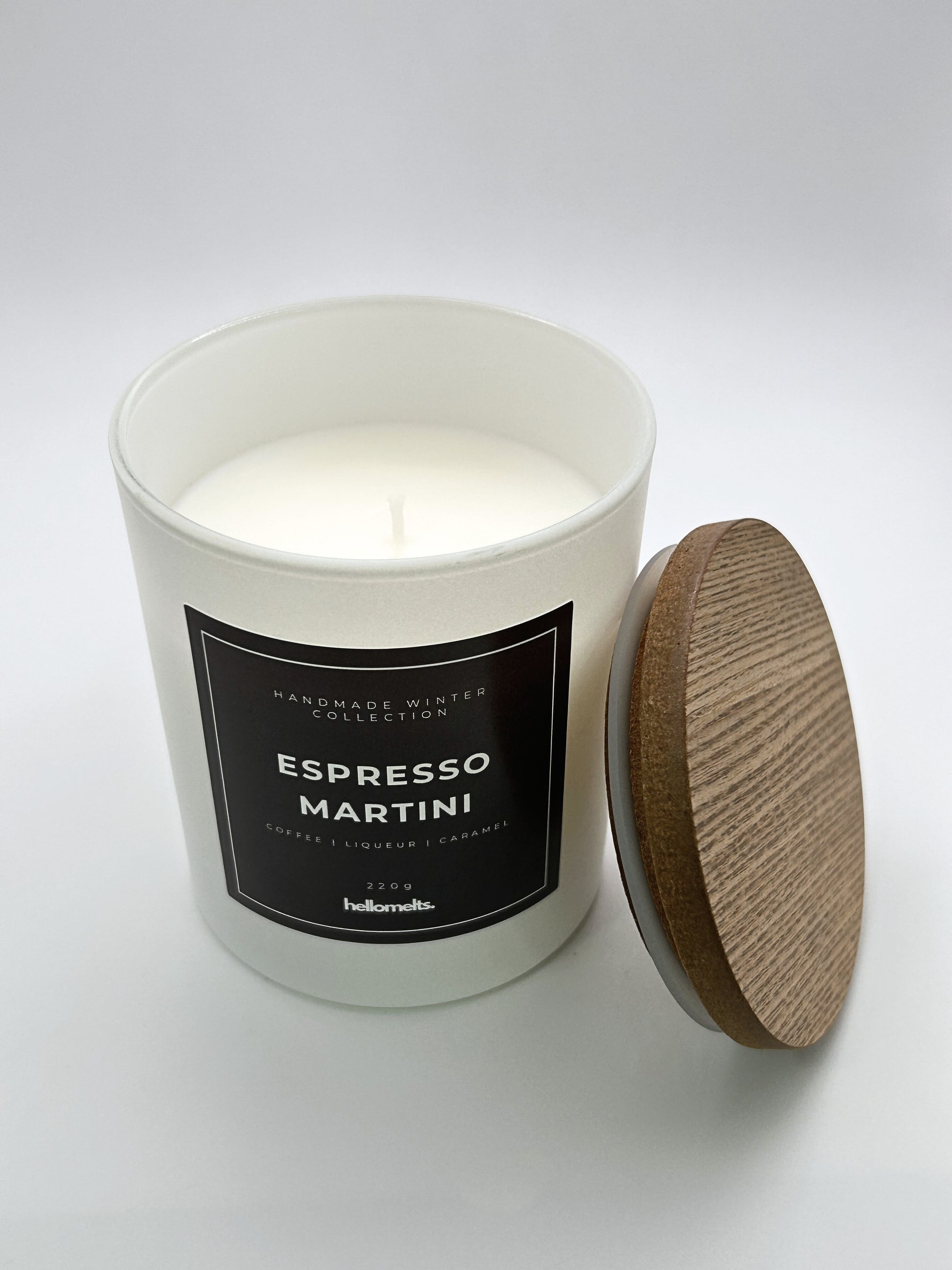 Espresso Martini 220g candle top-down view with the wooden lid placed beside the jar, part of the Hellomelts Winter Collection