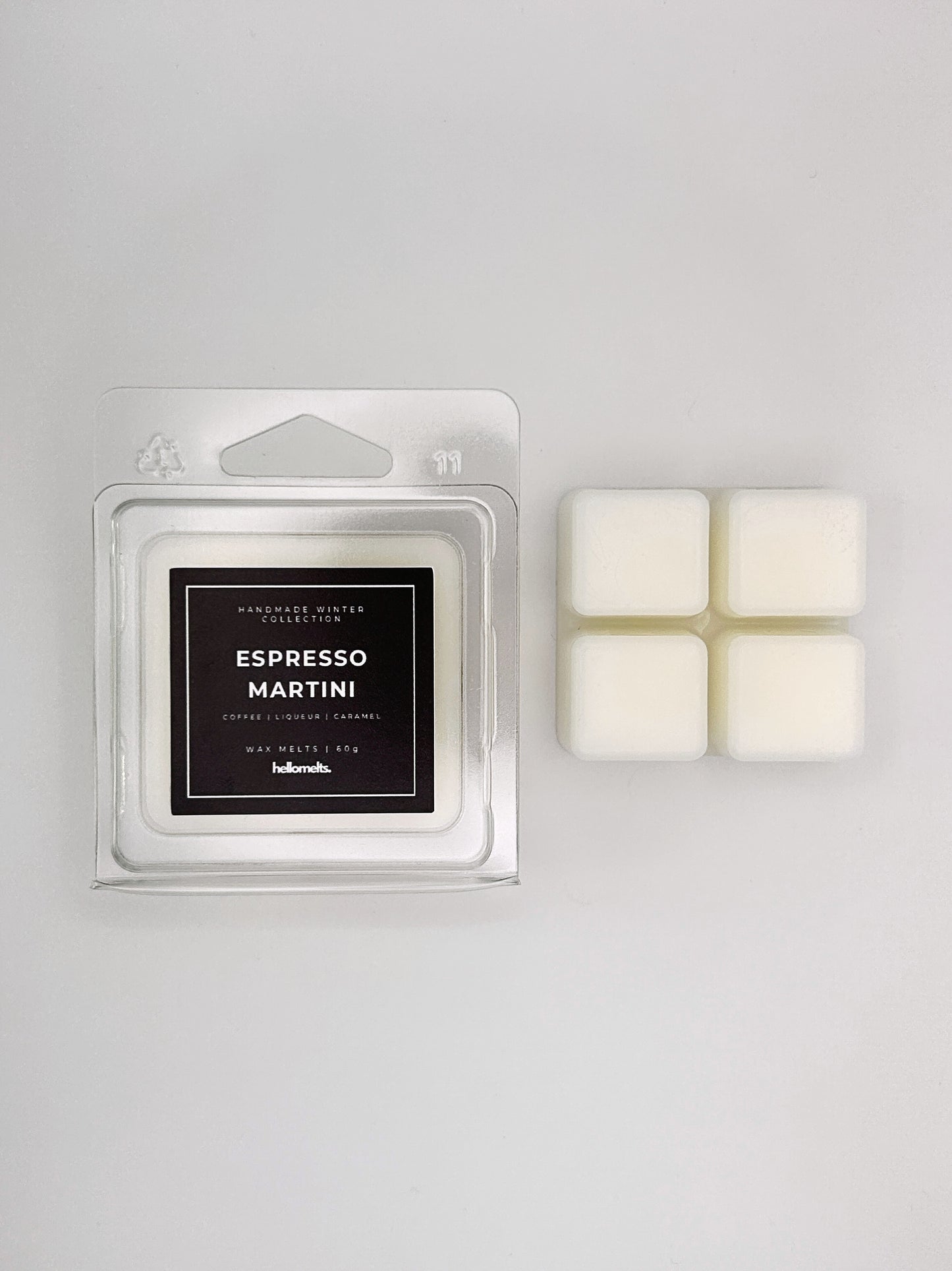 Espresso Martini 60g wax melt clamshell placed beside four wax cubes from the Hellomelts Winter Collection