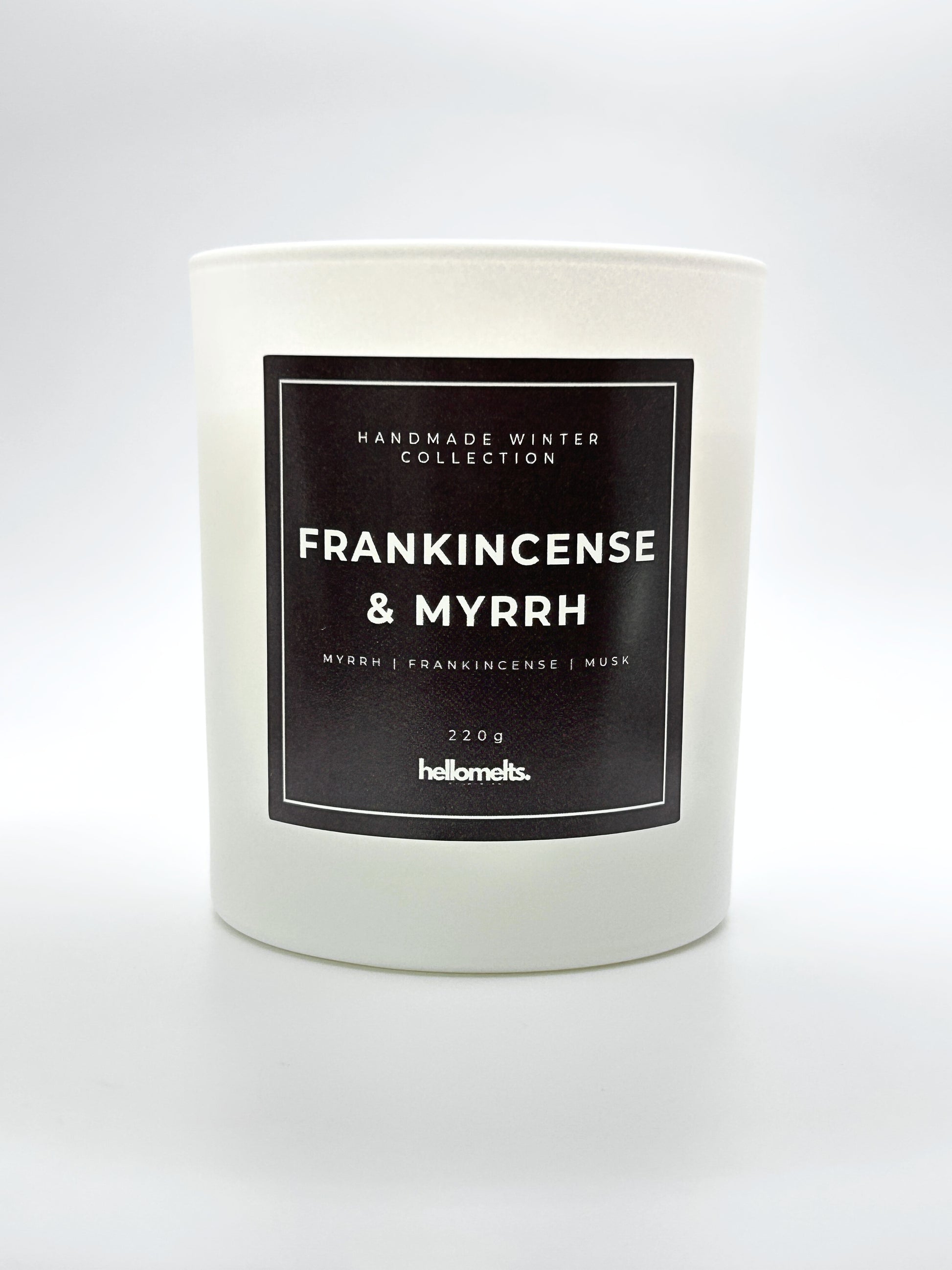 Frankincense & Myrrh 220g candle front-facing studio shot without the lid, showing the clean white jar and label from the Hellomelts Winter Collection