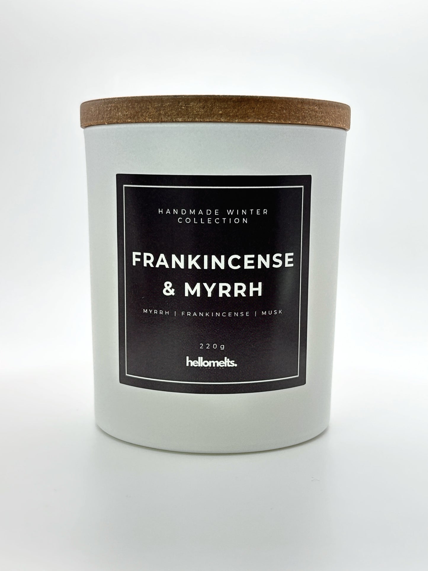 Frankincense & Myrrh 220g candle front-facing studio shot with wooden lid on, part of the Hellomelts Winter Collection