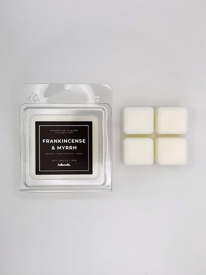 Frankincense & Myrrh 60g wax melt clamshell placed beside four wax cubes from the Hellomelts Winter Collection