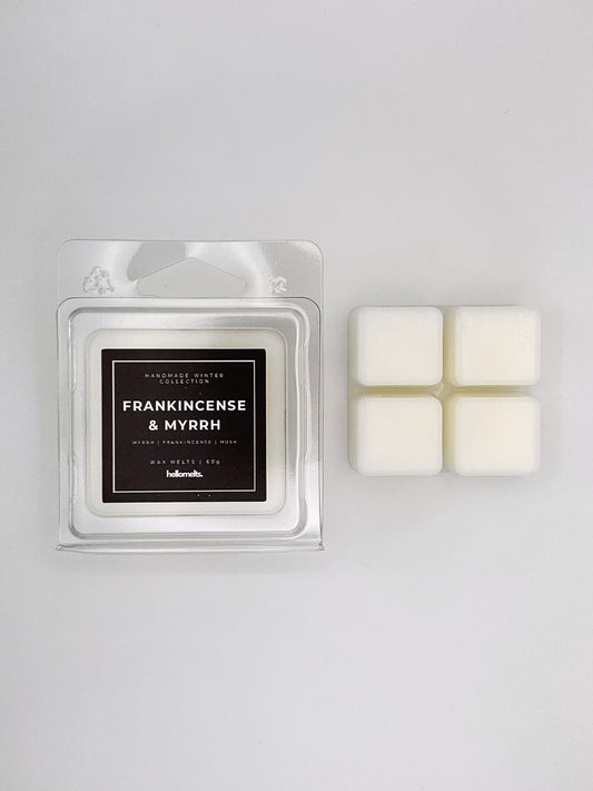 Frankincense & Myrrh 60g wax melt clamshell placed beside four wax cubes from the Hellomelts Winter Collection