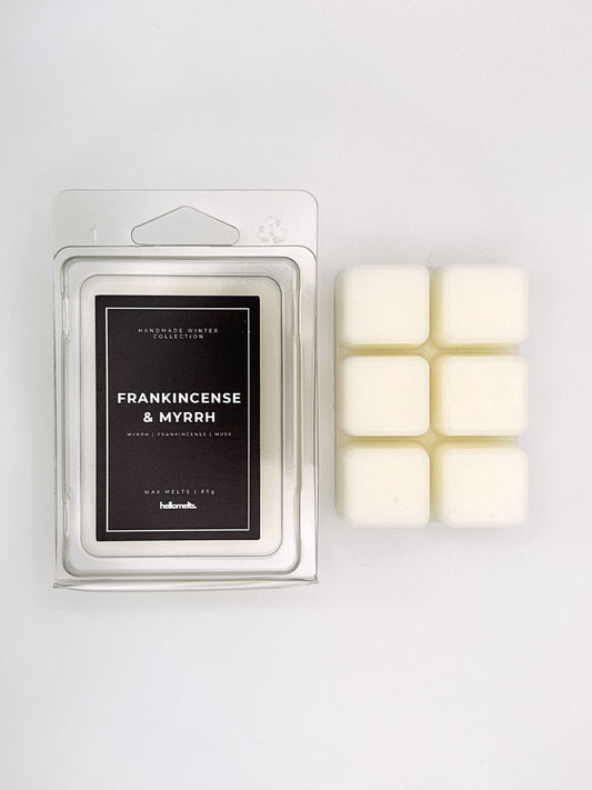 Frankincense & Myrrh 85g wax melt clamshell placed beside six wax cubes from the Hellomelts Winter Collection