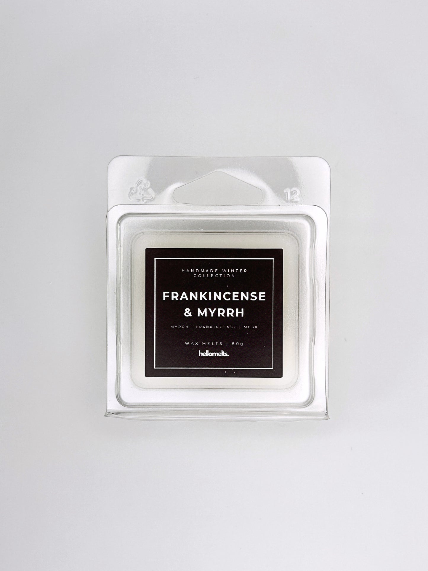 Frankincense & Myrrh 60g wax melt front-facing studio shot showing the clamshell packaging from the Hellomelts Winter Collection