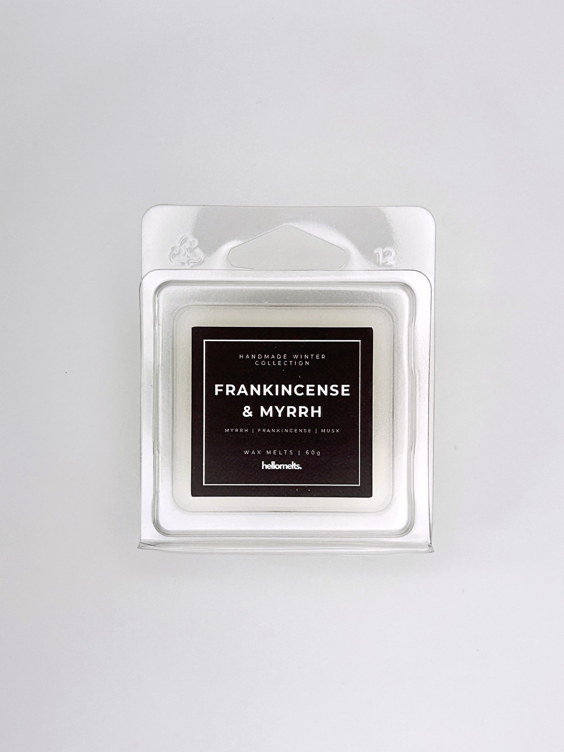 Frankincense & Myrrh 60g wax melt front-facing studio shot showing the clamshell packaging from the Hellomelts Winter Collection