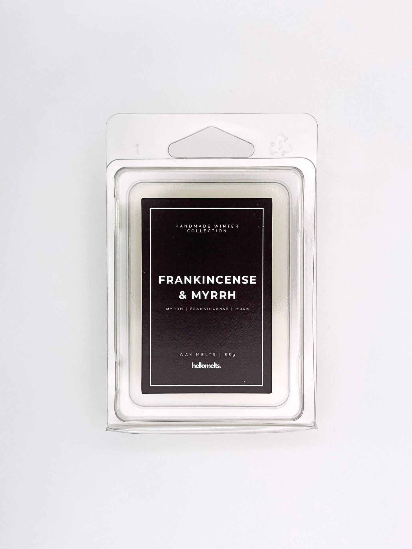 Frankincense & Myrrh 85g wax melt front-facing studio shot showing the clamshell packaging from the Hellomelts Winter Collection