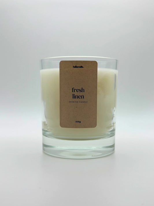 Front view of Fresh Linen scented candle by Hellomelts, featuring a clean white wax in a clear glass jar, part of the Spring Collection.