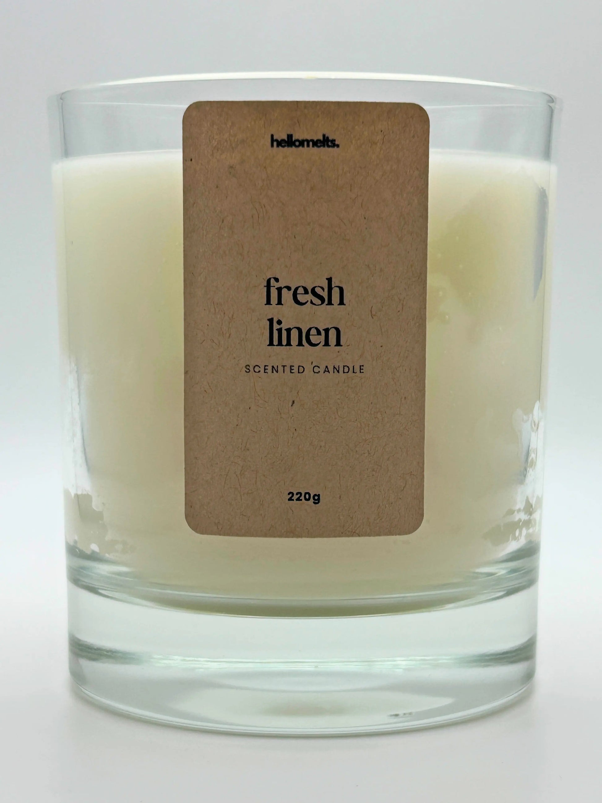 Close-up of the Fresh Linen candle label showing scent name and weight, a handcrafted candle by Hellomelts for the Spring Collection.