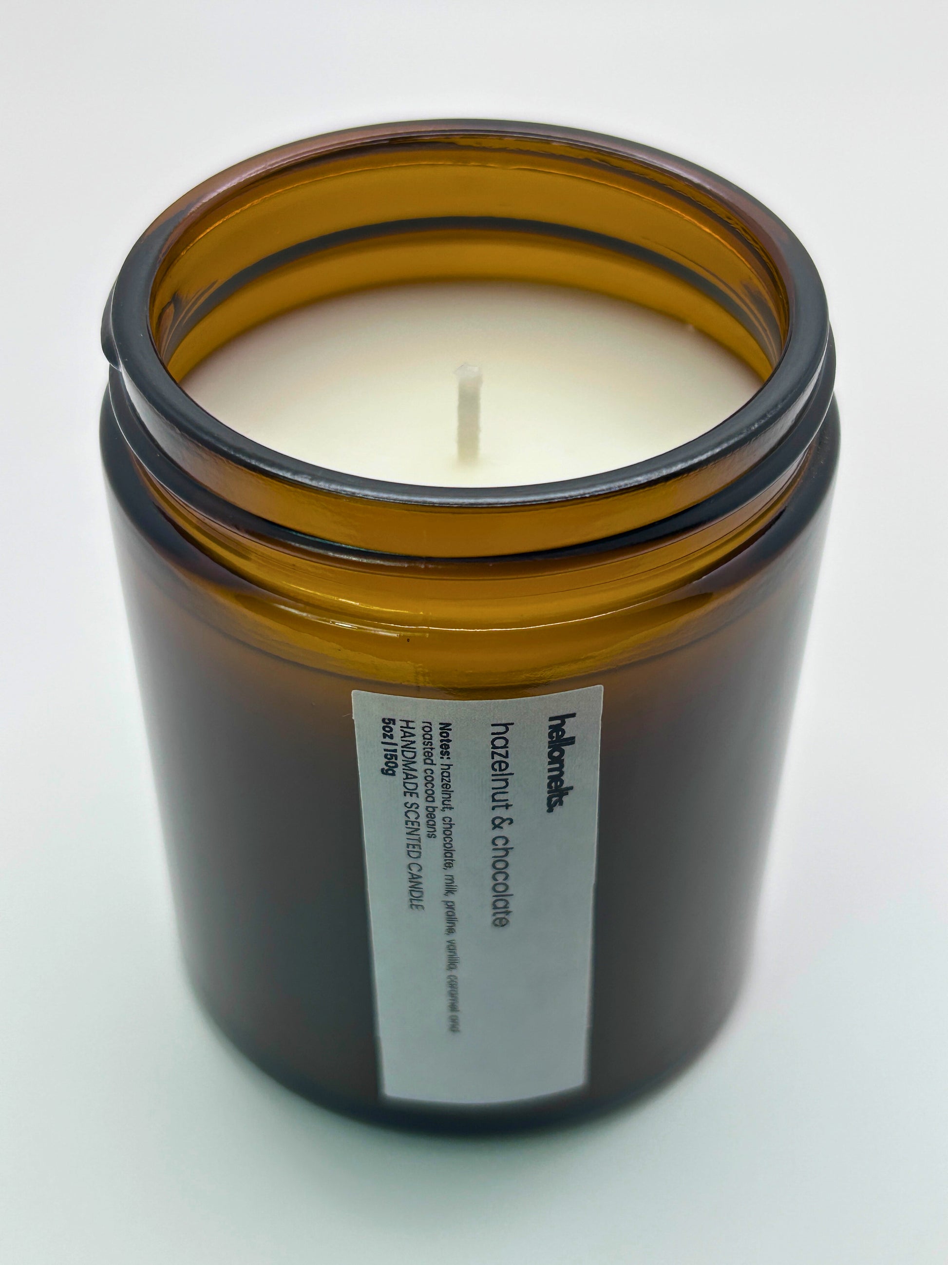 Angled top-down view of Hazelnut & Chocolate autumn candle by Hellomelts, highlighting the wick and hand-poured wax, part of the Autumn Collection