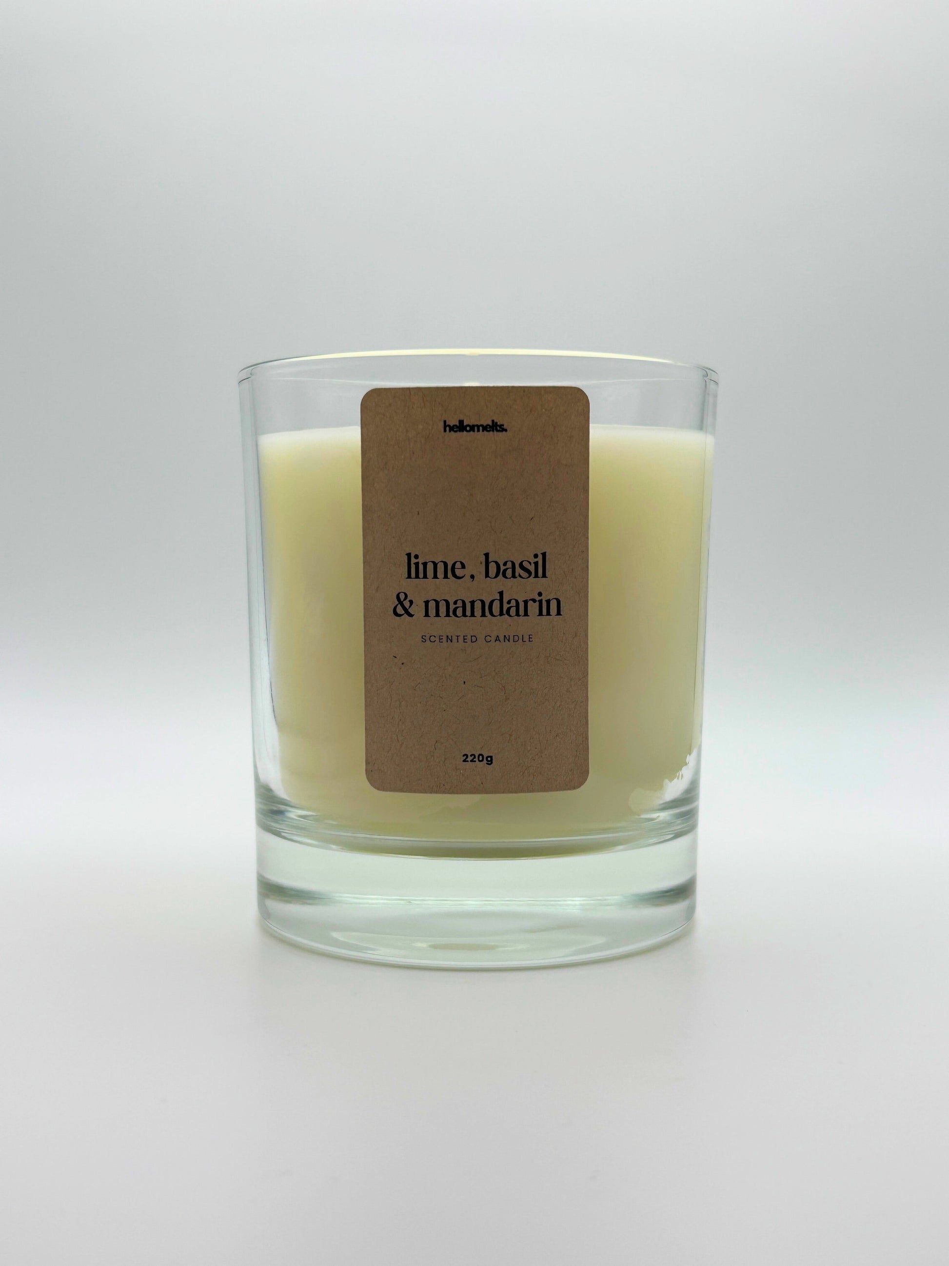 Front view of Lime, Basil & Mandarin scented candle by Hellomelts, featuring a clean off-white wax in a clear glass jar, part of the Spring Collection.