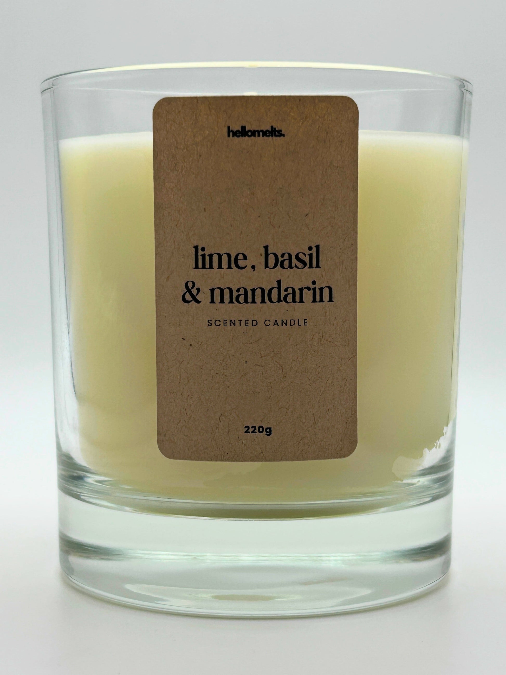Close-up of the Lime, Basil & Mandarin candle label showing scent name and weight, a handcrafted candle by Hellomelts for the Spring Collection.