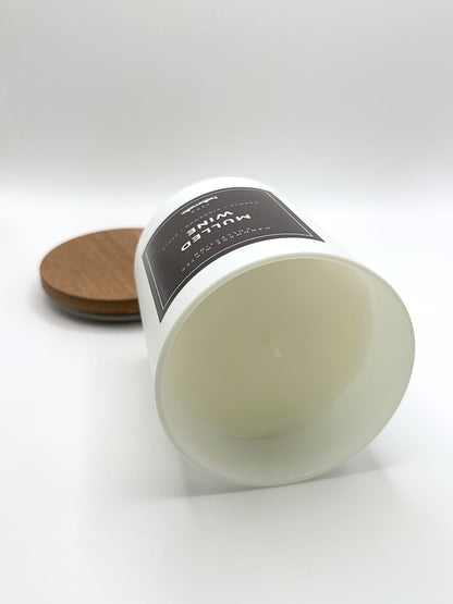 Mulled Wine 220g candle laid on its side with the lid in the background, showing the matte white jar from the Hellomelts Winter Collection