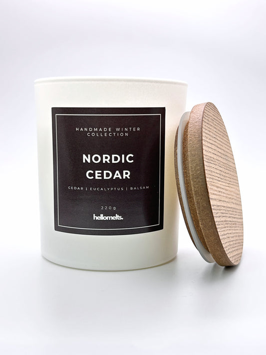 Nordic Cedar 220g candle front-facing studio shot with the wooden lid positioned at the side, part of the Hellomelts Winter Collection