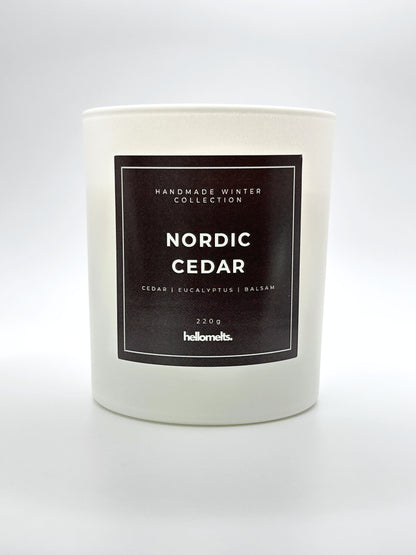 Nordic Cedar 220g candle front-facing studio shot without the lid, showing the clean white jar and label from the Hellomelts Winter Collection