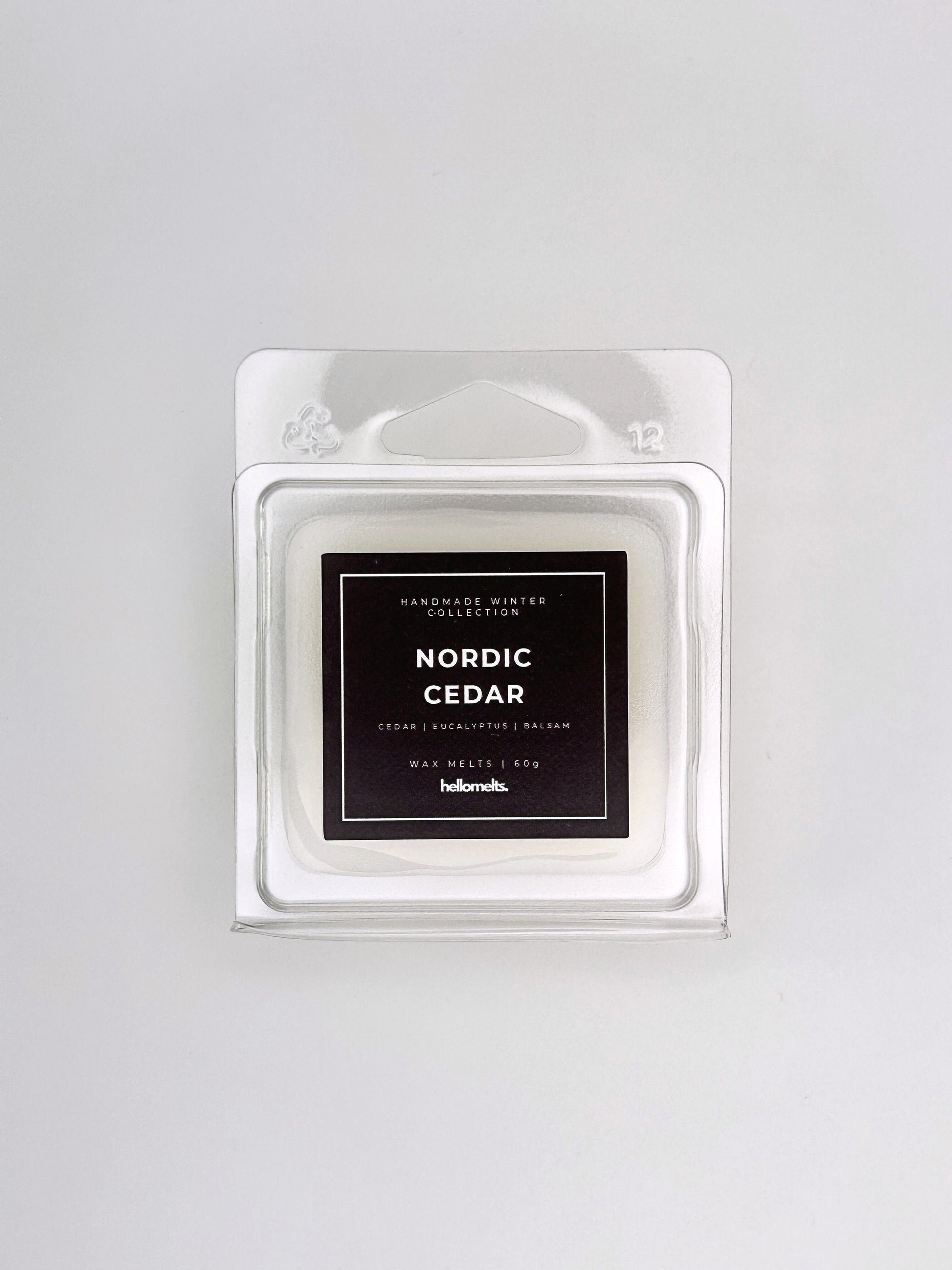 Nordic Cedar 60g wax melt front-facing studio shot showing the clamshell packaging from the Hellomelts Winter Collection
