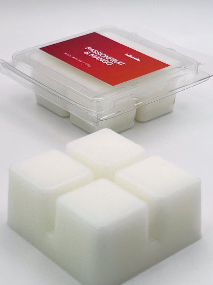 Angled shot of Passionfruit & Mango 60g wax melt bar in front of its packaging, part of the Summer Collection by Hellomelts