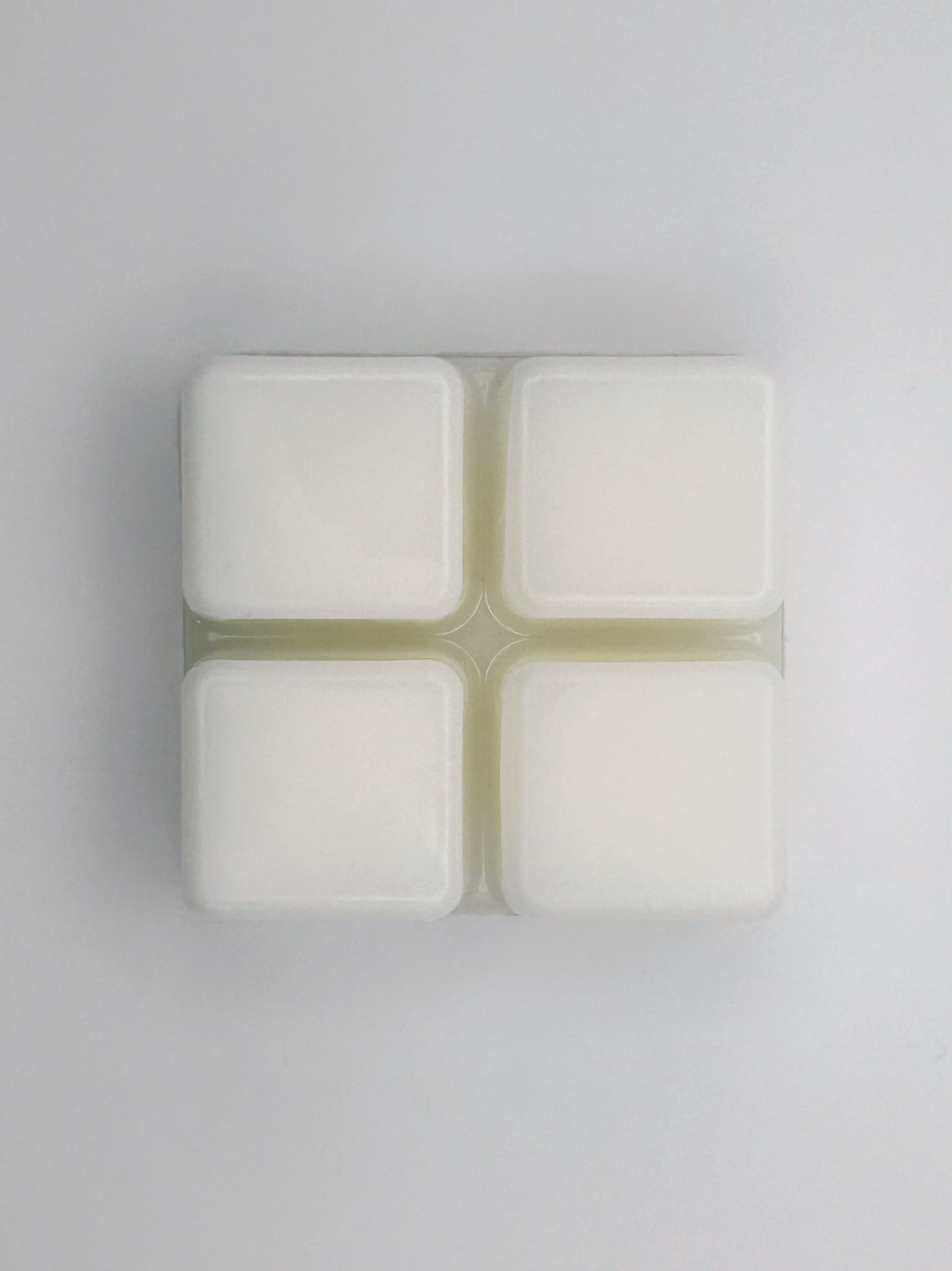 Flatlay of Passionfruit & Mango wax melt bar in 60g size, removed from packaging to show 4 cubed wax melt bar