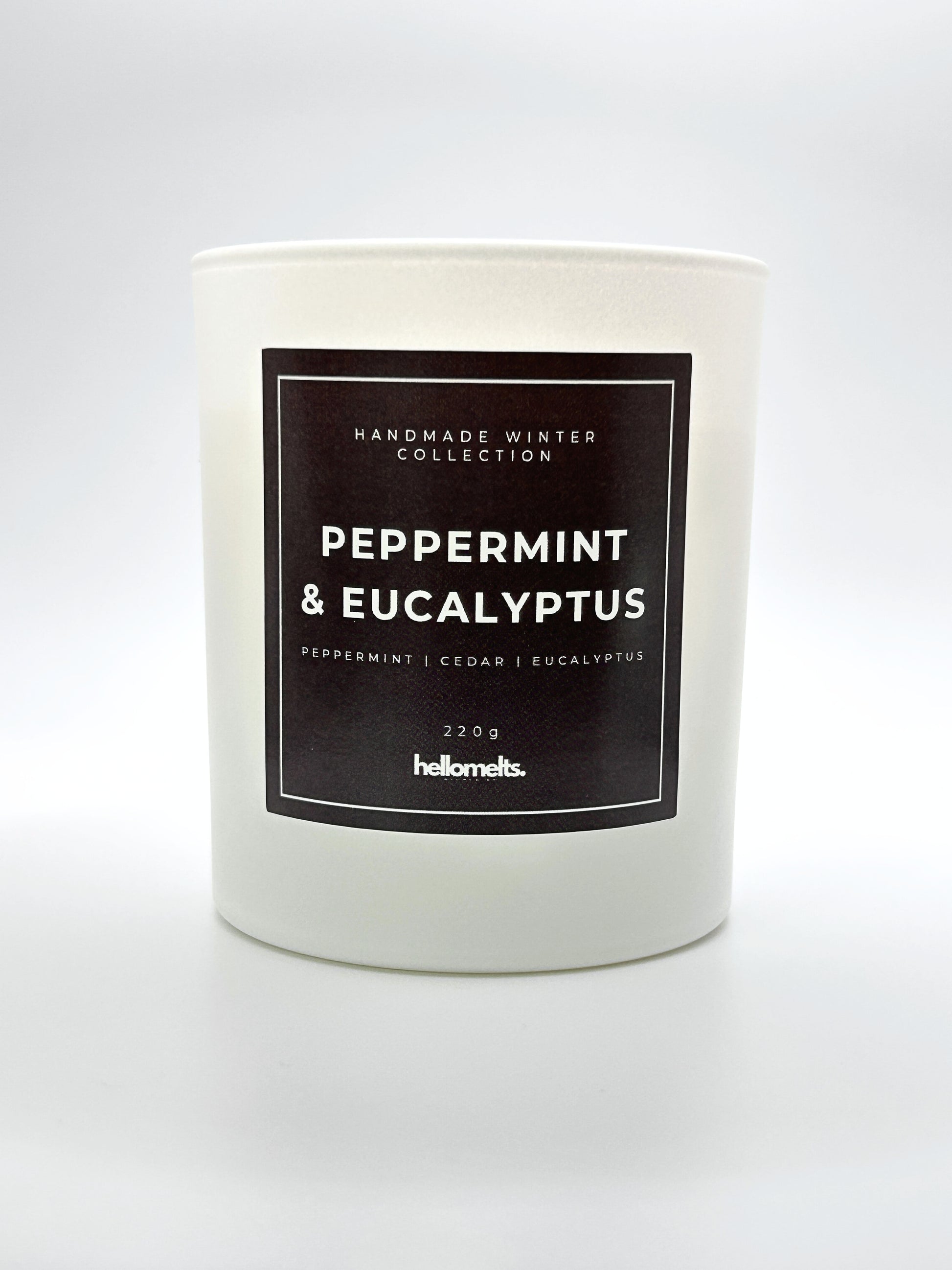 Peppermint & Eucalyptus 220g candle front-facing studio shot without the lid, showing the clean white jar and label from the Hellomelts Winter Collection