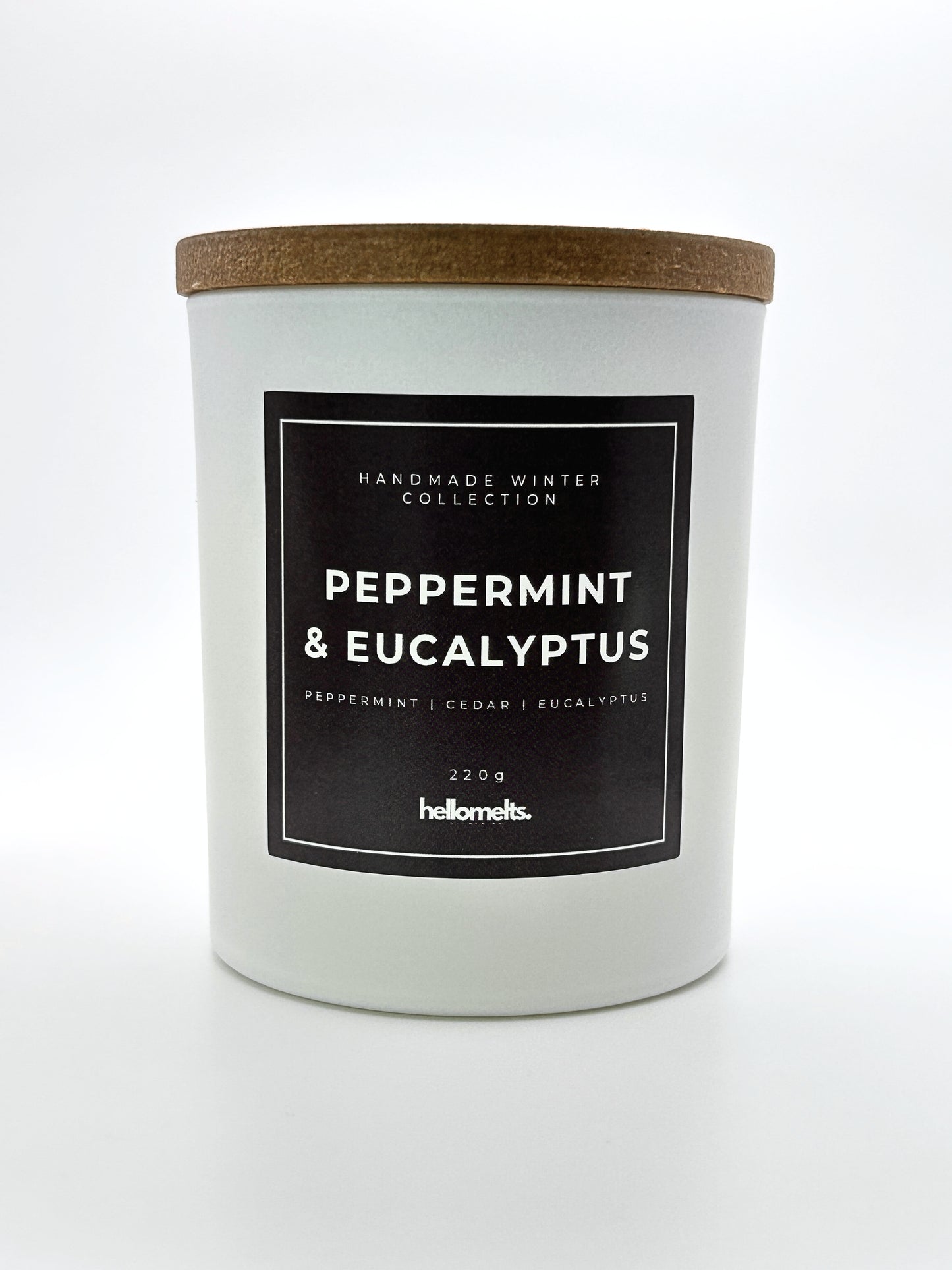 Peppermint & Eucalyptus 220g candle front-facing studio shot with wooden lid on, part of the Hellomelts Winter Collection