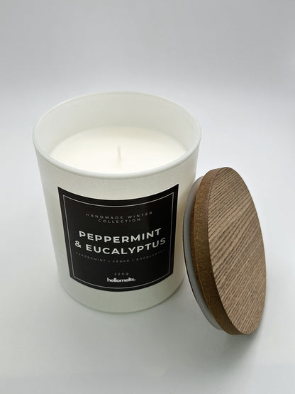 Peppermint & Eucalyptus 220g candle top-down view with the wooden lid placed beside the jar, part of the Hellomelts Winter Collection