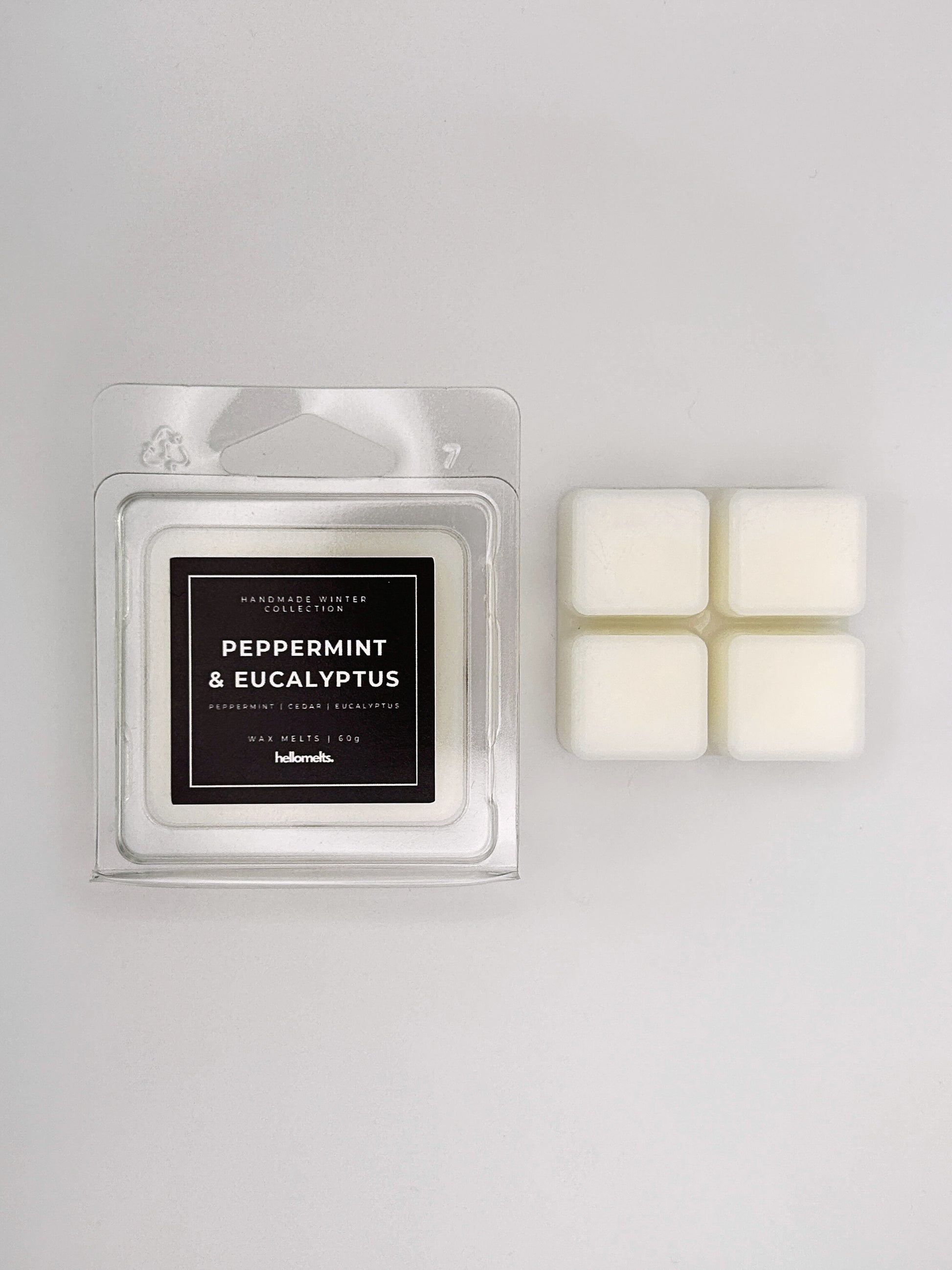 Peppermint & Eucalyptus 60g wax melt clamshell placed beside four wax cubes from the Hellomelts Winter Collection
