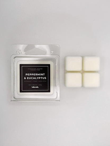Peppermint & Eucalyptus 60g wax melt clamshell placed beside four wax cubes from the Hellomelts Winter Collection
