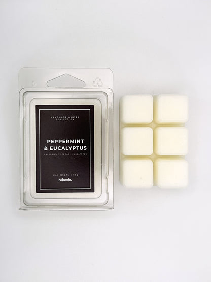 Peppermint & Eucalyptus 85g wax melt clamshell placed beside six wax cubes from the Hellomelts Winter Collection